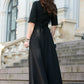 Black maxi dress with circle skirts. Golden color detail in neckline