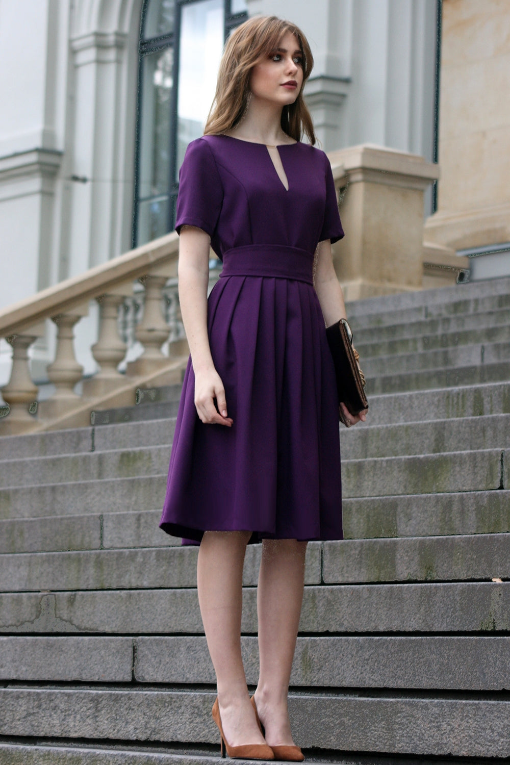 Full purple dress with pleats. Gold detail in neckline