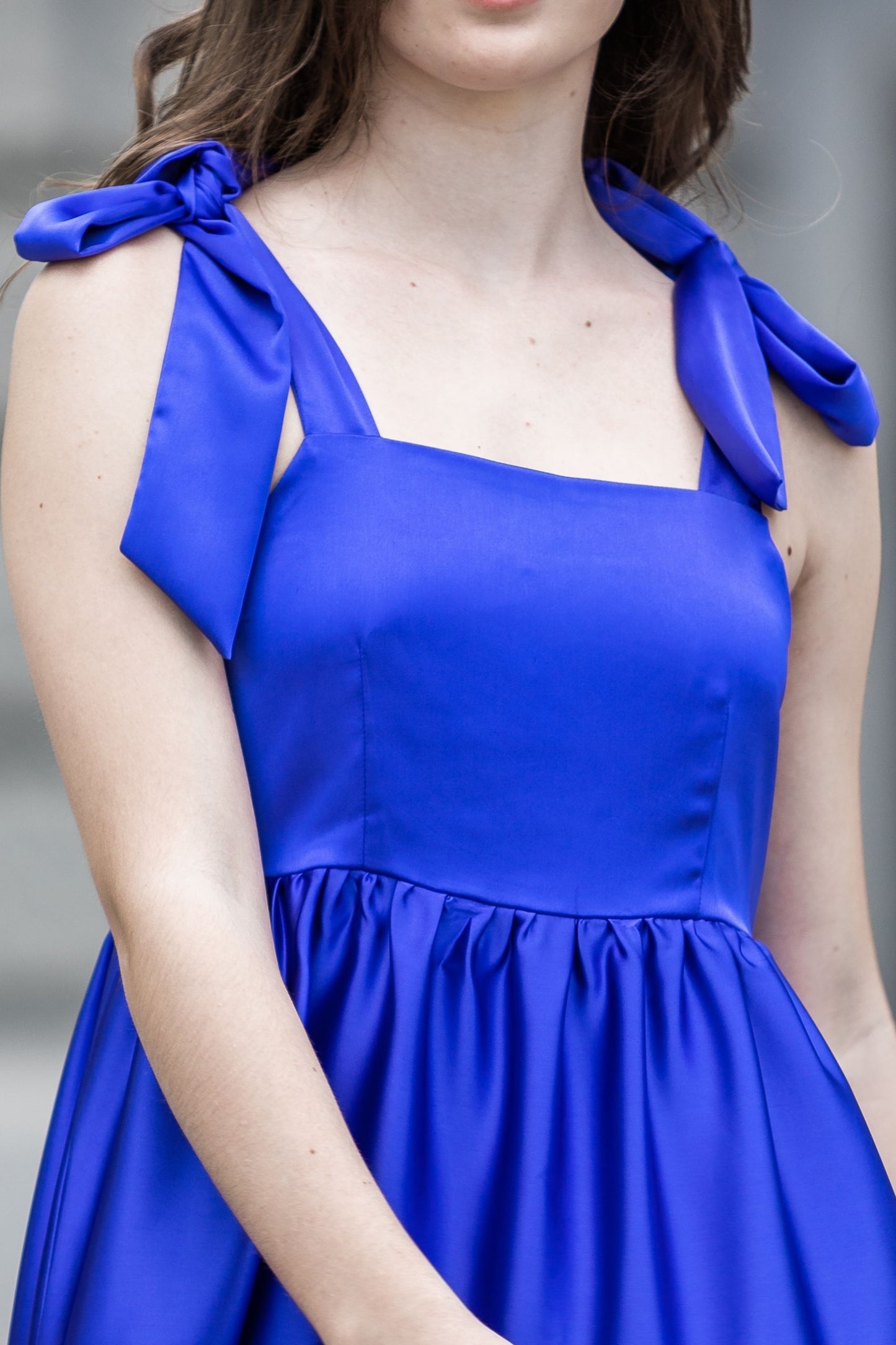 Royal blue satin dress with bows on the shoulders