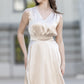 Vanilla color half-length cocktail dress with a bow