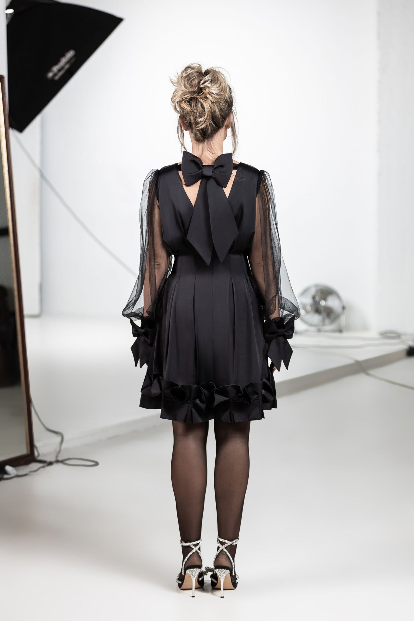 Elegant black satin dress with bows