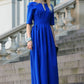 Blue long dress with pleats. Golden color detail in neckline