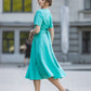 Turquoise dress with circle skirts. Golden color detail in neckline
