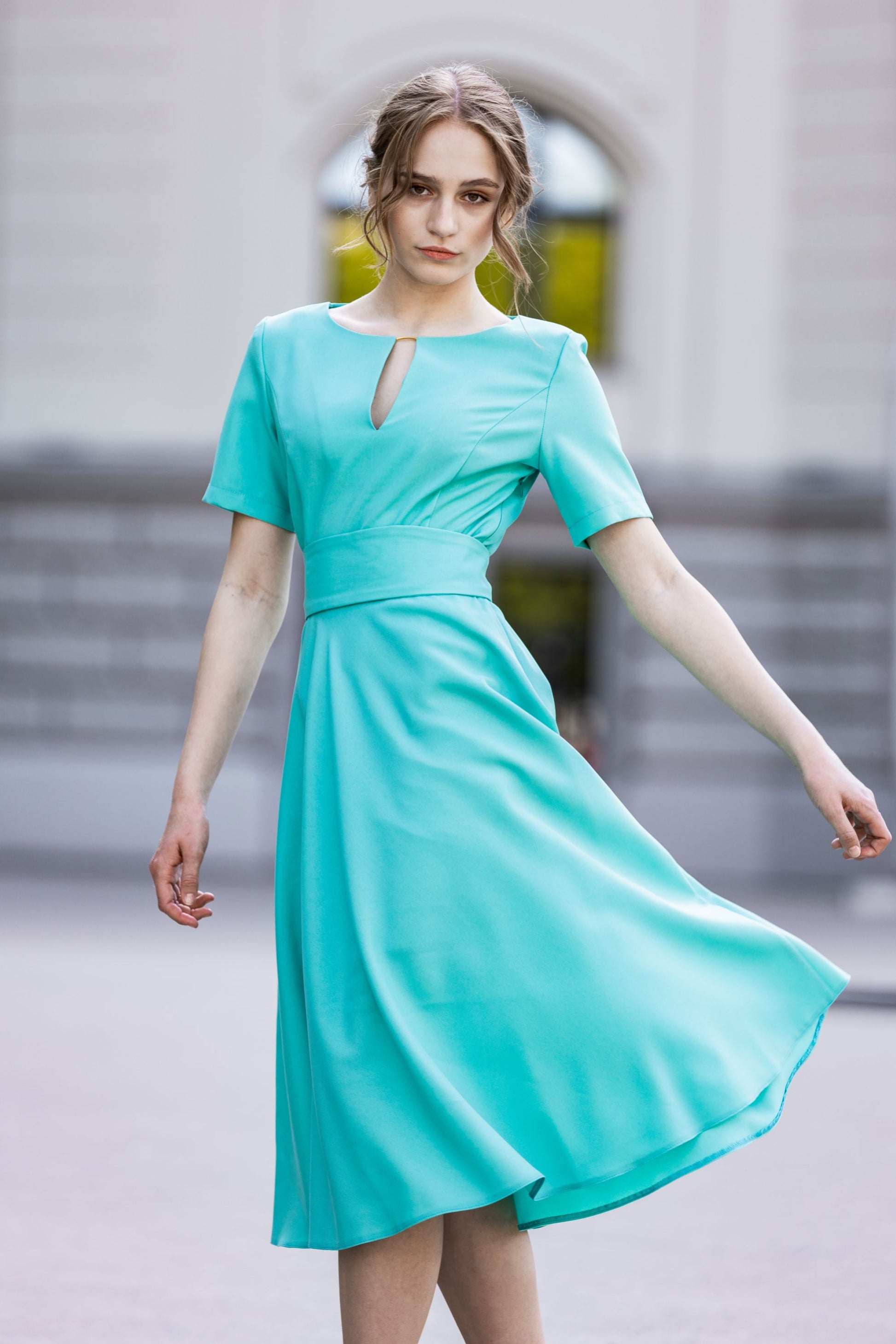 Turquoise dress with circle skirts. Golden color detail in neckline GUNTINA Turquoise dress with circle skirts. Golden color detail in neckline GUNTINA