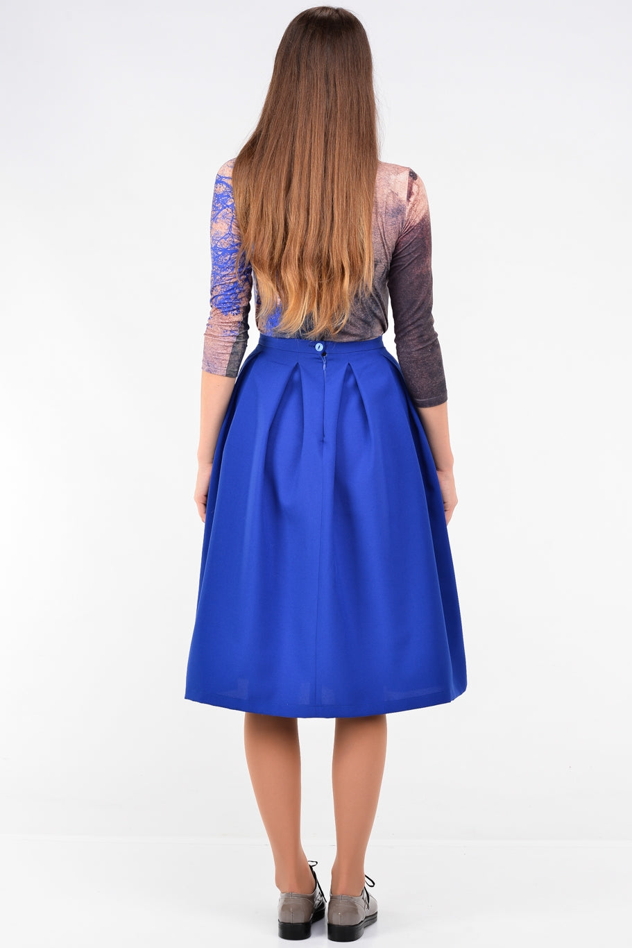Blue knee length skirts with pleats and pockets