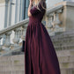 Long dress in grape shade with pleats. Golden color detail in neckline