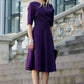 Dark purple dress with circle skirts. Golden color detail in neckline