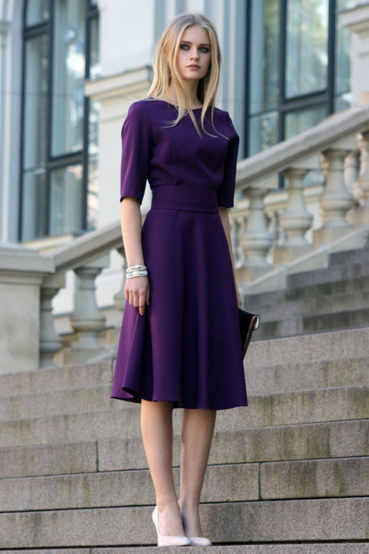 Dark purple dress with circle skirts. Golden color detail in neckline