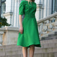 Green dress with circle skirts. Golden color detail in neckline