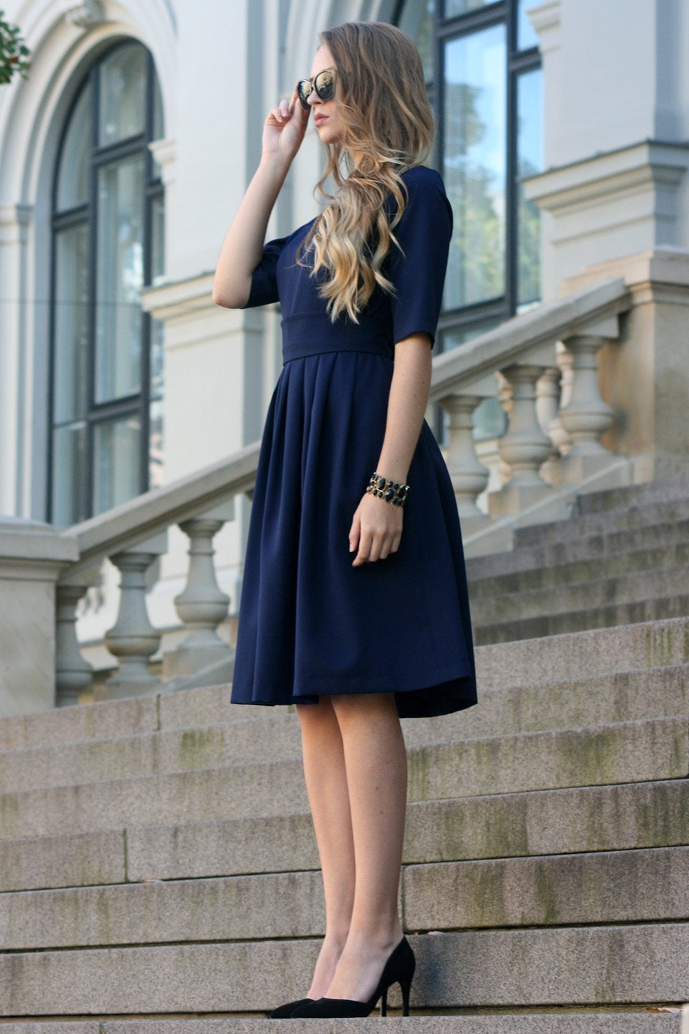 Dark blue dress with pleats. Golden color detail in neckline GUNTINA Dark blue dress with pleats. Golden color detail in neckline GUNTINA