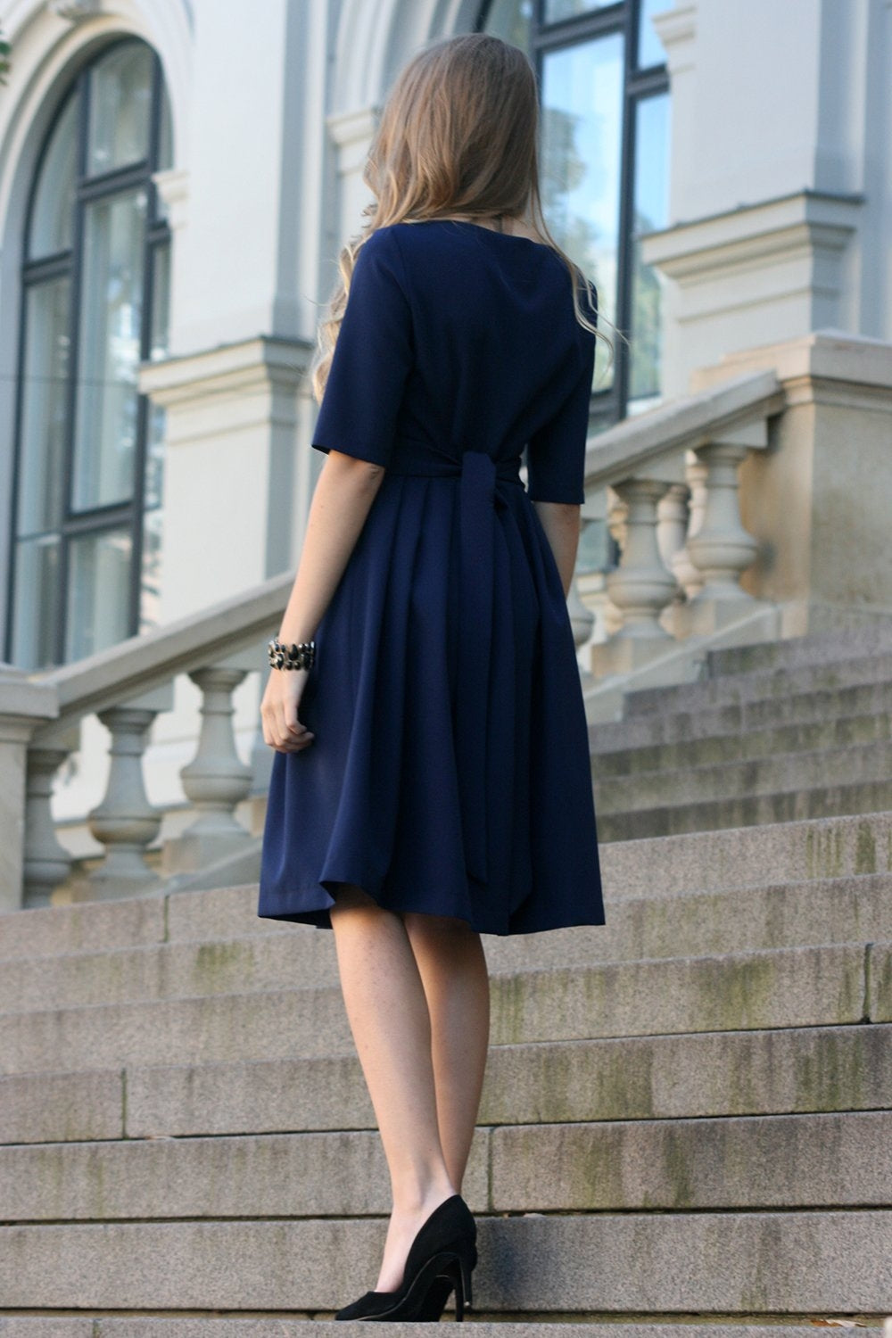 Dark blue dress with pleats. Golden color detail in neckline GUNTINA Dark blue dress with pleats. Golden color detail in neckline GUNTINA