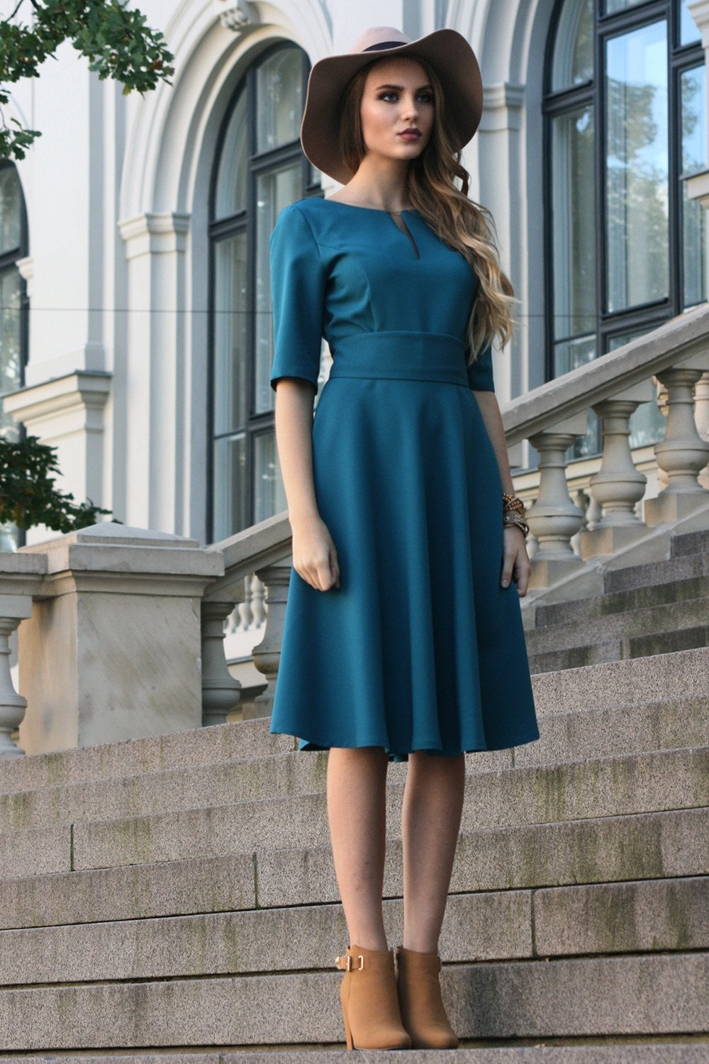 Blue green dress with circle skirts. Golden color detail in neckline