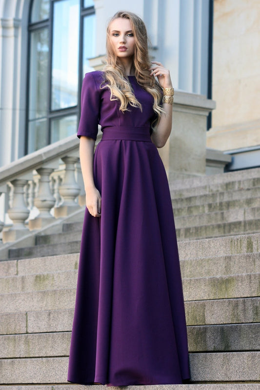 Dark purple maxi dress with circle skirts. Golden color detail in neckline
