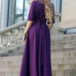 Dark purple maxi dress with circle skirts. Golden color detail in neckline