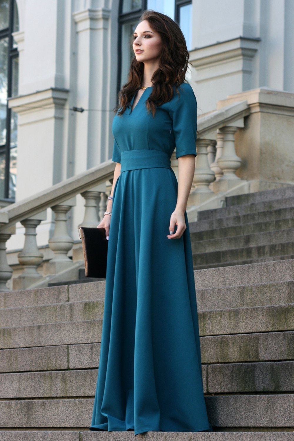 Blue green maxi dress with circle skirts. Golden color detail in neckline
