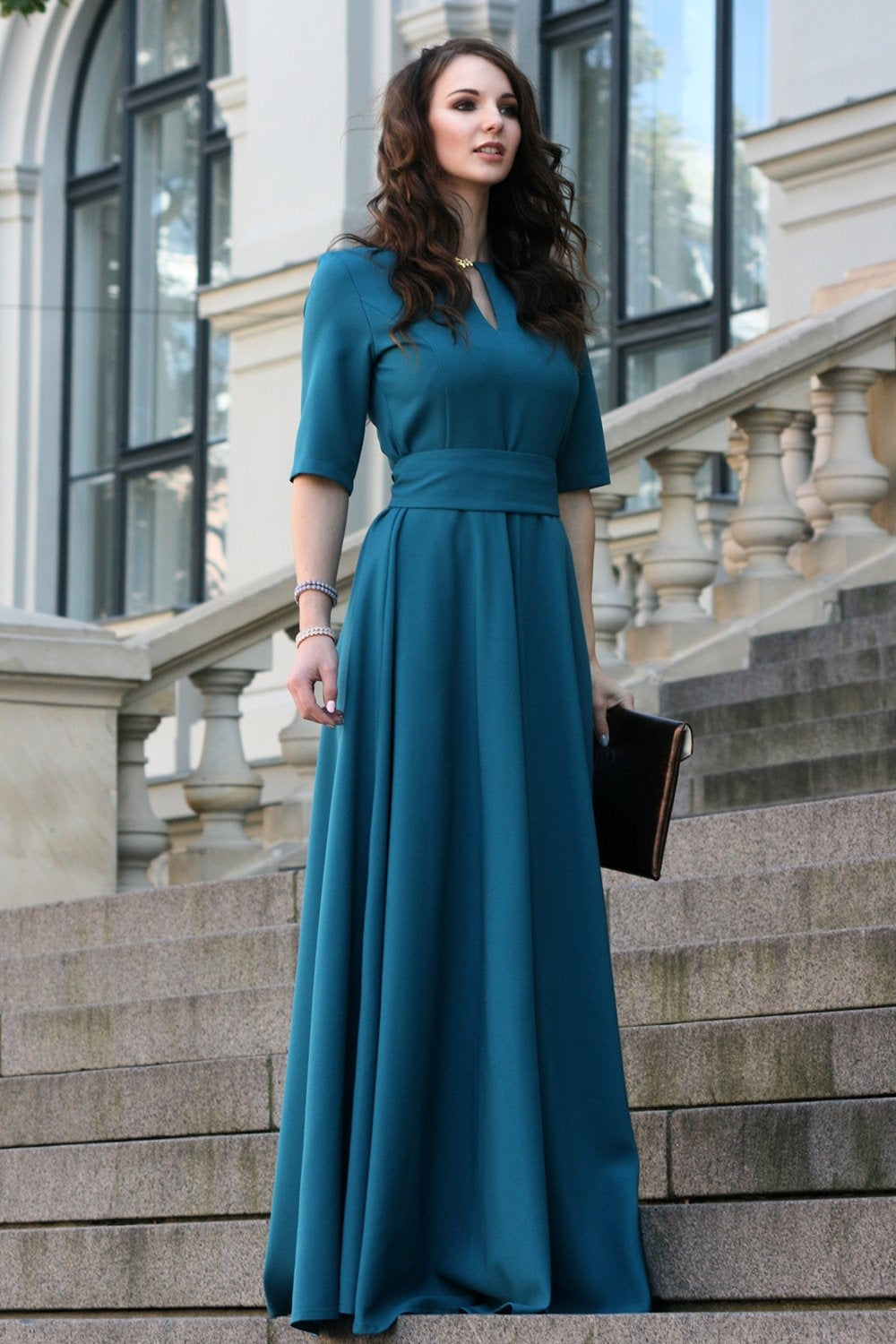 Blue green maxi dress with circle skirts. Golden color detail in neckline
