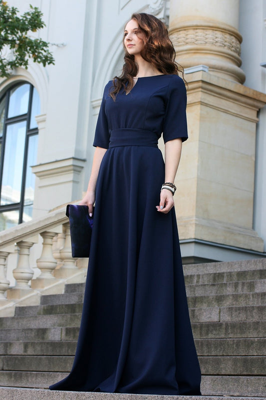 Dark blue maxi dress with circle skirts. Golden color detail in neckline