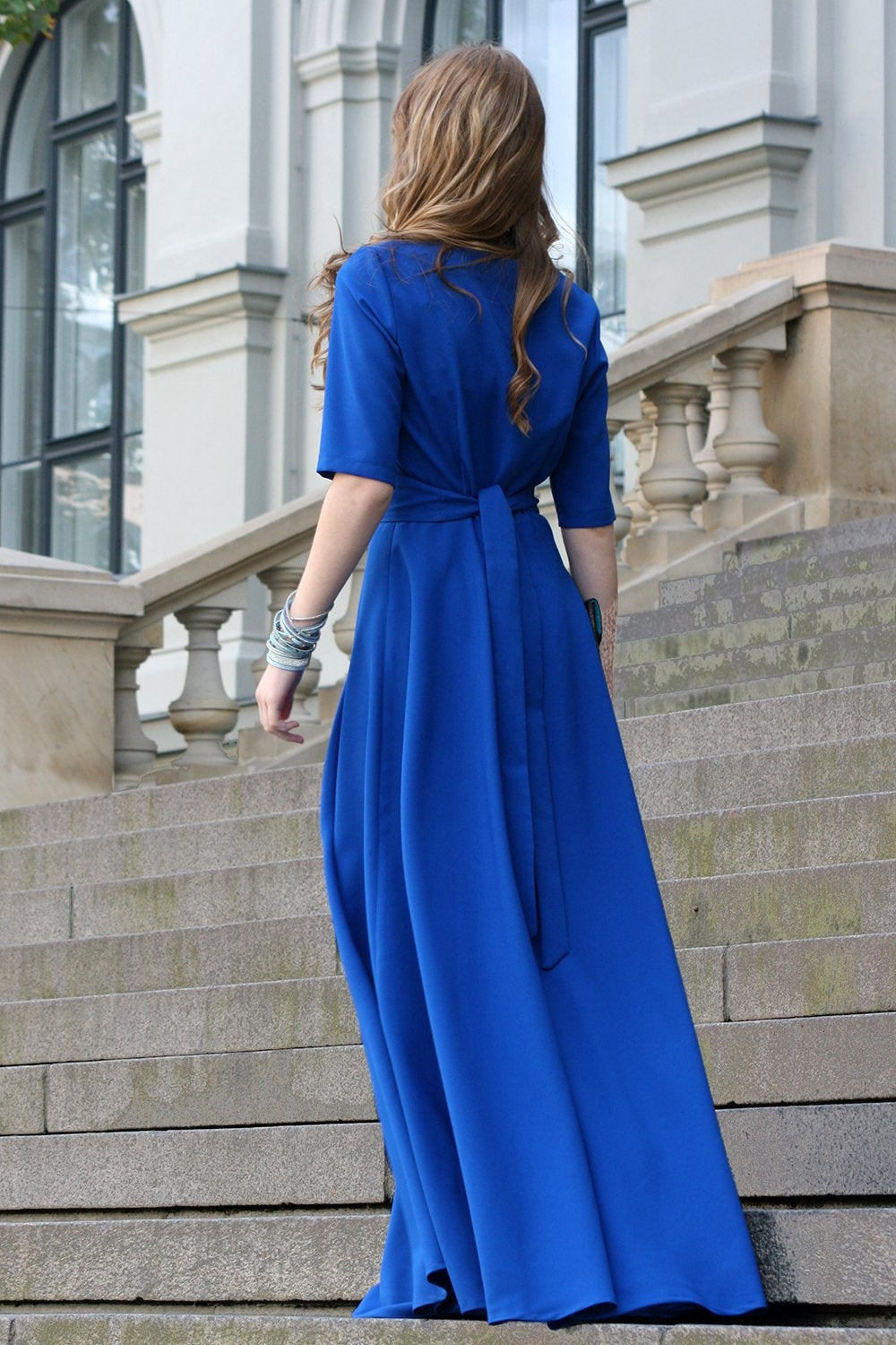 Blue maxi dress with circle skirts. Golden color detail in neckline