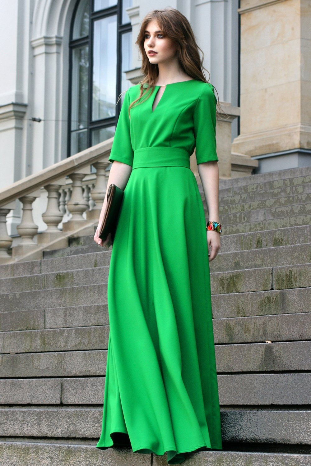 Green maxi dress with circle skirts. Golden color detail in neckline