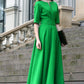 Green maxi dress with circle skirts. Golden color detail in neckline