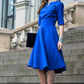 Blue dress with circle skirts. Golden color detail in neckline