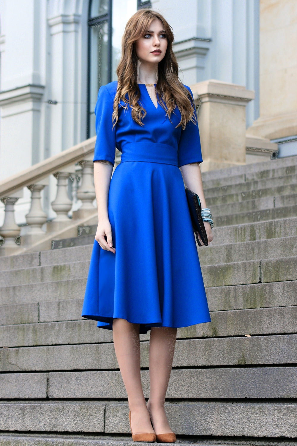 Blue dress with circle skirts. Golden color detail in neckline