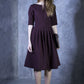 Grape shade dress with pleats. Golden color detail in neckline